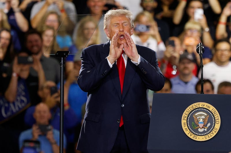 U.S. President Donald Trump puts his hands to his face, as he delivers remarks on the economy, at the General Motors Proving Ground in Milford, Michigan, U.S. July 27, 2026.  REUTERS/Carlos Osorio