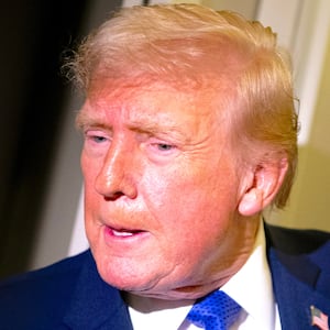 President Donald Trump speaks to members of the media aboard Air Force One while flying from Palm Beach International Airport on February 16, 2026.