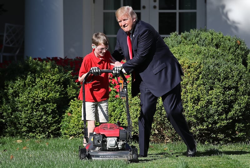 11-year-old Frank Giaccio gets a pat on the back from Trump while mowing the grass in the Rose Garden of the White House ,September 15, 2017.