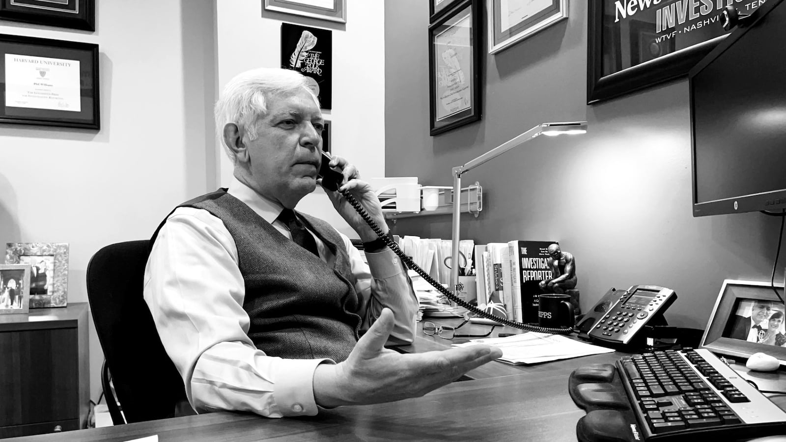 A photograph of Phil Williams on the phone working inside his Nashville office.