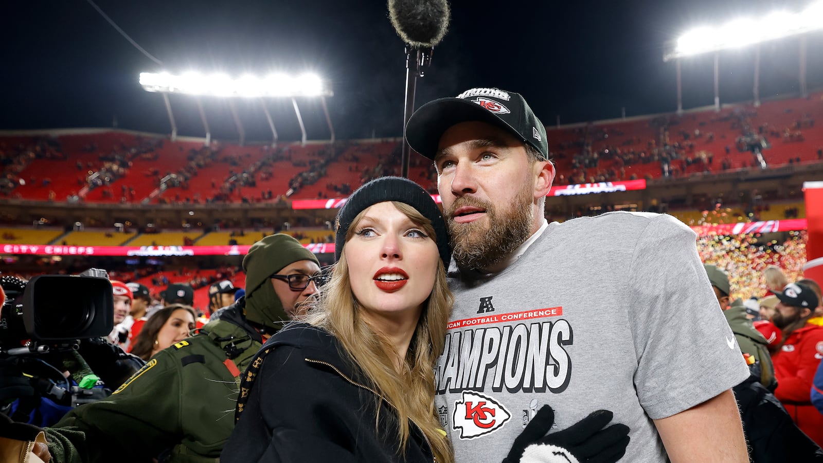KANSAS CITY, MISSOURI - JANUARY 26: Taylor Swift celebrates with Travis Kelce #87 of the Kansas City Chiefs after defeating the Buffalo Bills 32-29 in the AFC Championship Game at GEHA Field at Arrowhead Stadium on January 26, 2025 in Kansas City, Missouri. (Photo by David Eulitt/Getty Images)