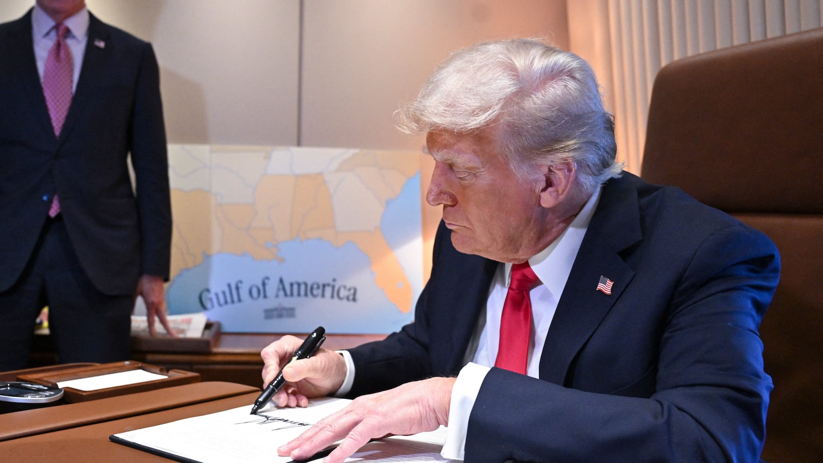President Donald Trump signs a proclamation renaming the Gulf of Mexico as the Gulf of America aboard Air Force One enroute to New Orleans, Louisiana on Febrary 09, 2025.