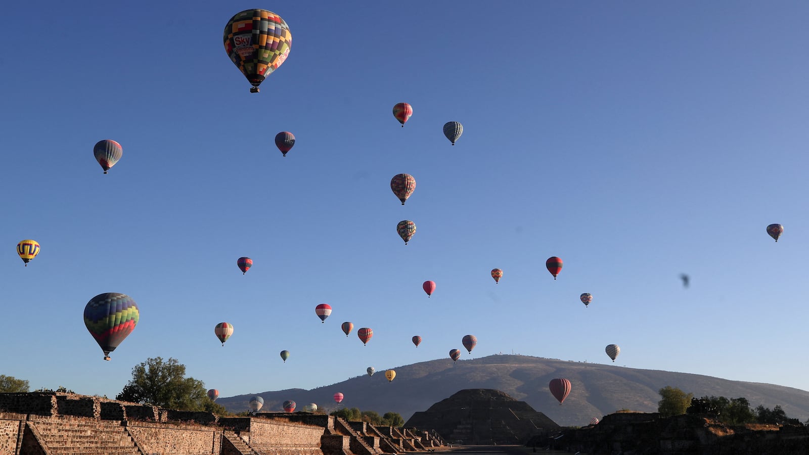 Hot air balloons float above the Pyramid of the Moon on the day of the spring equinox in the pre-hispanic city of Teotihuacan, on the outskirts of Mexico City, Mexico, March 20, 2023.