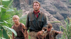 Actor Sam Neill as Dr. Alan Grant, with Ariana Richards (left) and Joseph Mazzello (right) as Lex and Tim, in a scene from the film 'Jurassic Park', 1993.