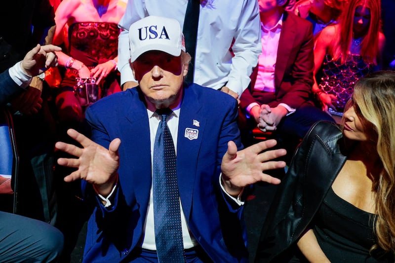 President Donald Trump gestures next to first lady Melania Trump during UFC Freedom 250 on the South Lawn of the White House in Washington, D.C., U.S., June 15, 2026.