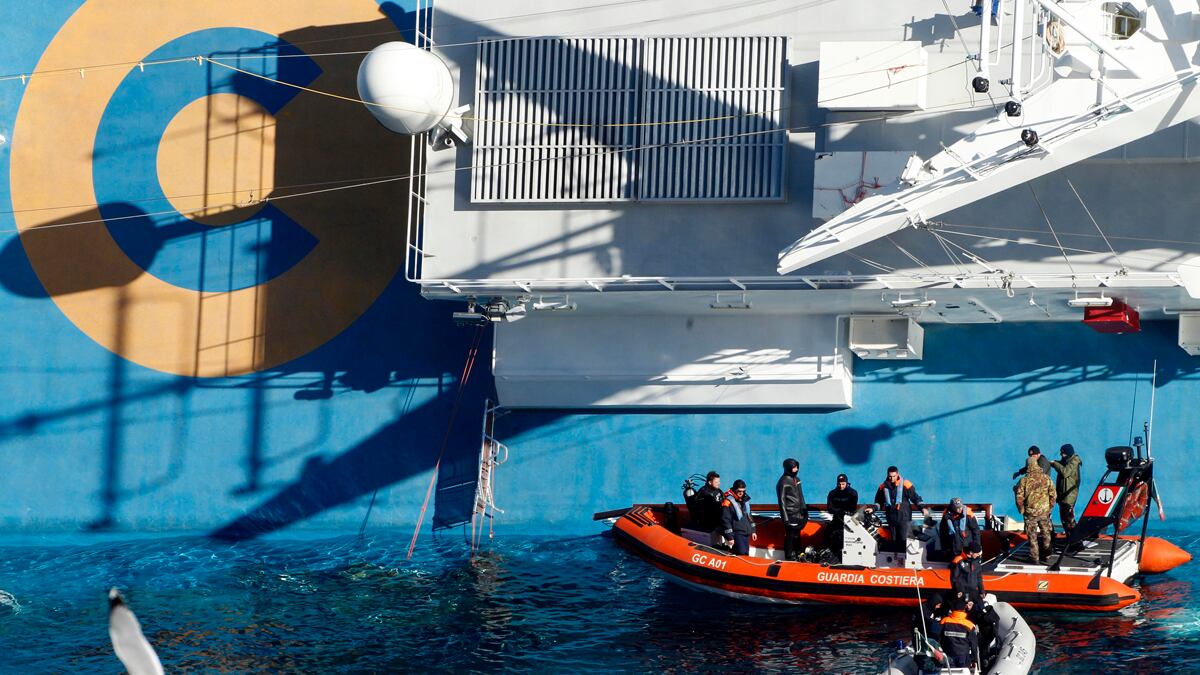 articles/2012/01/26/costa-concordia-legal-battle-gets-ugly/concordia-cruise-ship-sinking-update-scapegoat-barbie_pufh0r