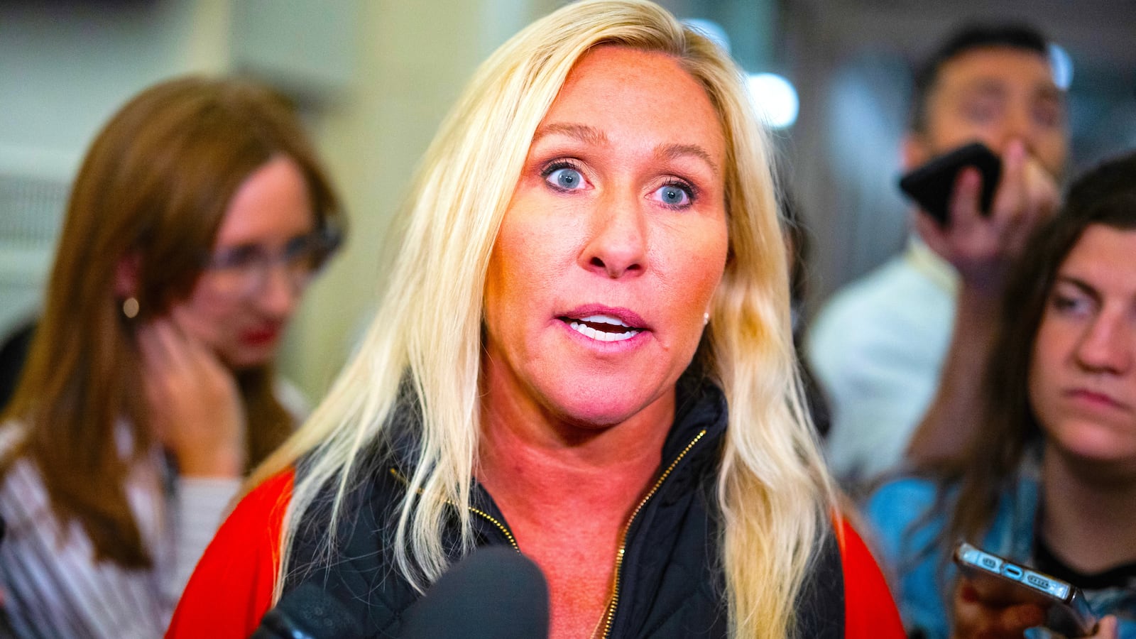 Rep. Marjorie Taylor Greene, R-Ga., talks with reporters in the Longworth Building on Tuesday, October 10, 2023.
