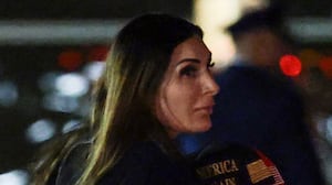 JOINT BASE ANDREWS, MARYLAND - OCTOBER 02: Political activist Laura Loomer follows behind U.S. President Donald Trump as he walks off Air Force One on October 02, 2026 in Joint Base Andrews, Maryland. Trump travelled to Mobile, Alabama for a campaign rally. (Photo by Anna Moneymaker/Getty Images)