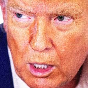 Donald Trump slack jawed in front of a piece of a f-15 jet that was shot down by Iran