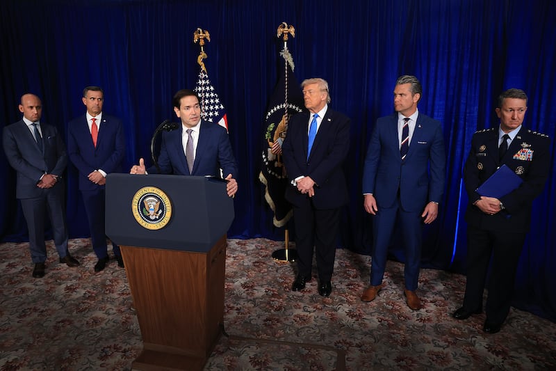 PALM BEACH, FLORIDA - JANUARY 03: Secretary of State Marco Rubio speaks during a press conference as (L to R) Homeland Security Advisor Stephen Miller, CIA Director John Ratcliffe, U.S. President Donald Trump, Secretary of War Pete Hegseth and Chairman of the Joint Chiefs of Staff Dan Caine listen at Mar-a-Lago club on January 03, 2026, in Palm Beach, Florida. During the event, President Trump confirmed that the United States military carried out a large-scale strike in Caracas overnight, resulting in the capture of Venezuelan leader Nicolás Maduro and his wife, Cilia Flores.  (Photo by Joe Raedle/Getty Images)