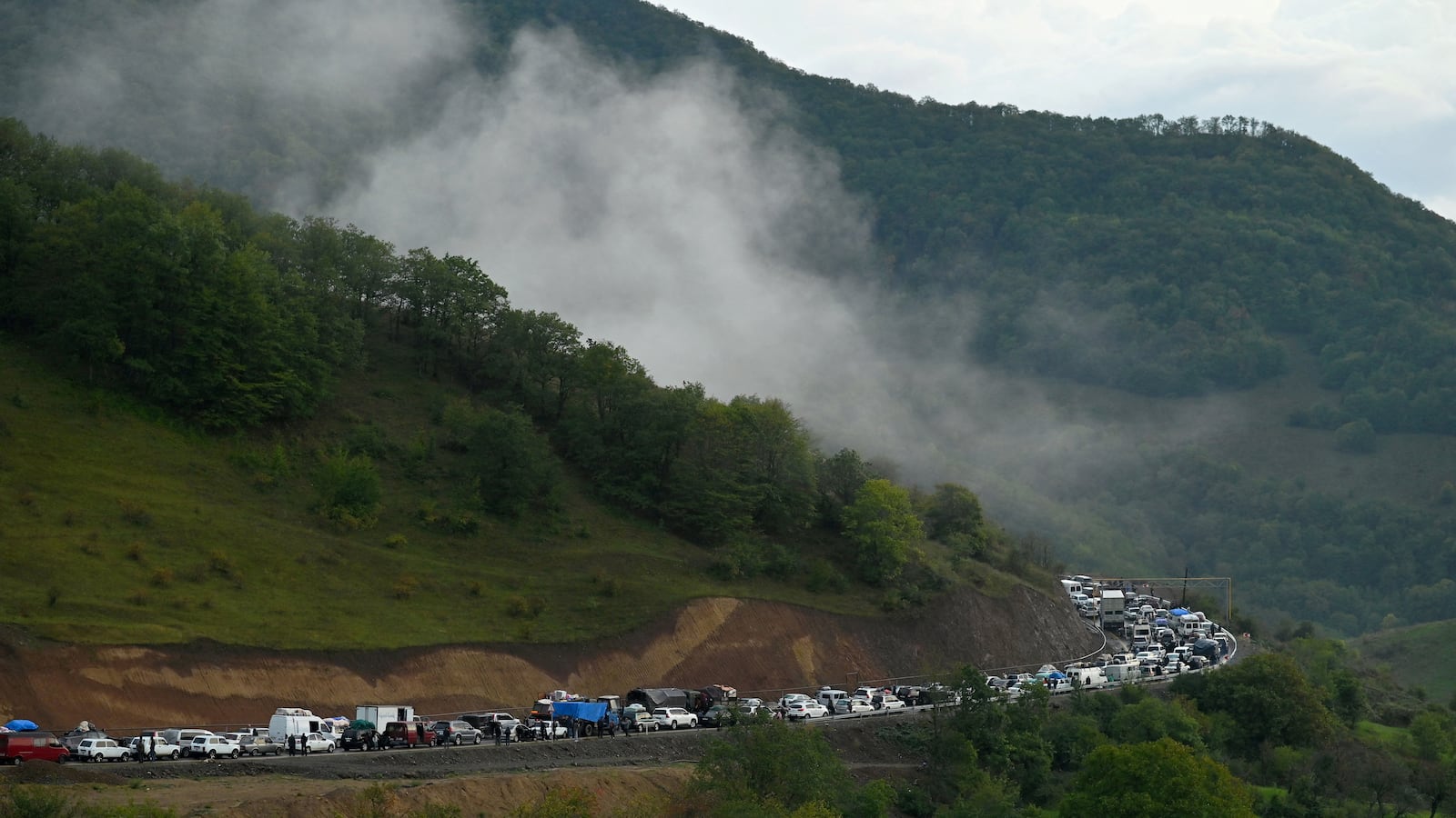 Vehicles carrying refugees from Nagorno-Karabakh queue on the road leading toward the Armenian border, in Nagorno-Karabakh, Sept. 25, 2023.