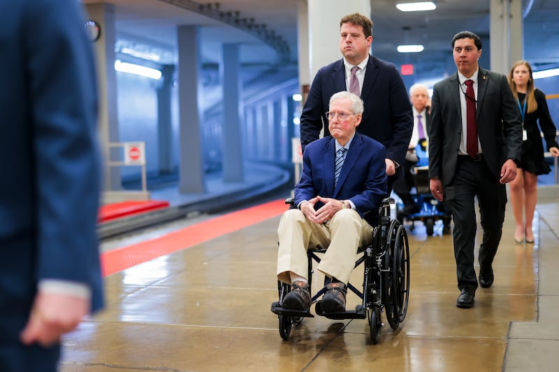Mitch McConnell is pushed in a wheelchair through the Senate Subway during the Senate War Powers vote on April 22, 2026 in Washington, DC.