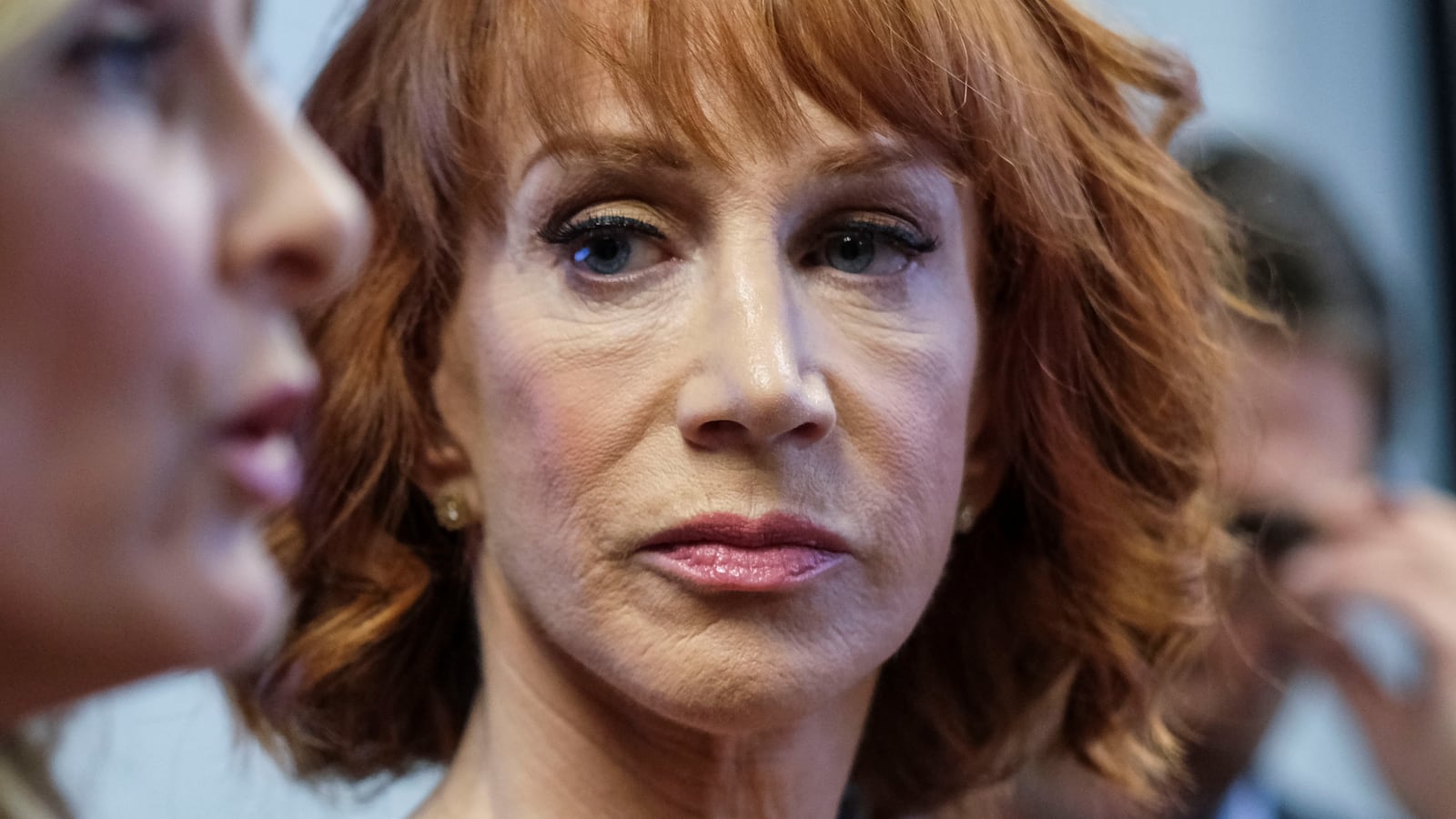 Kathy Griffin watches as her attorney speaks at a news conference