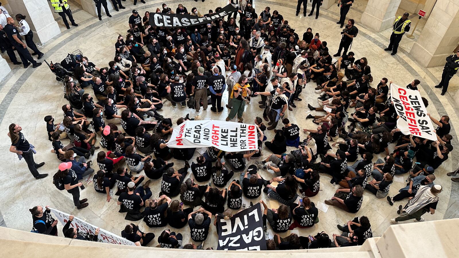 Protesters sit in the middle of the Capitol Rotunda to protest the war between Israel and Hamas.