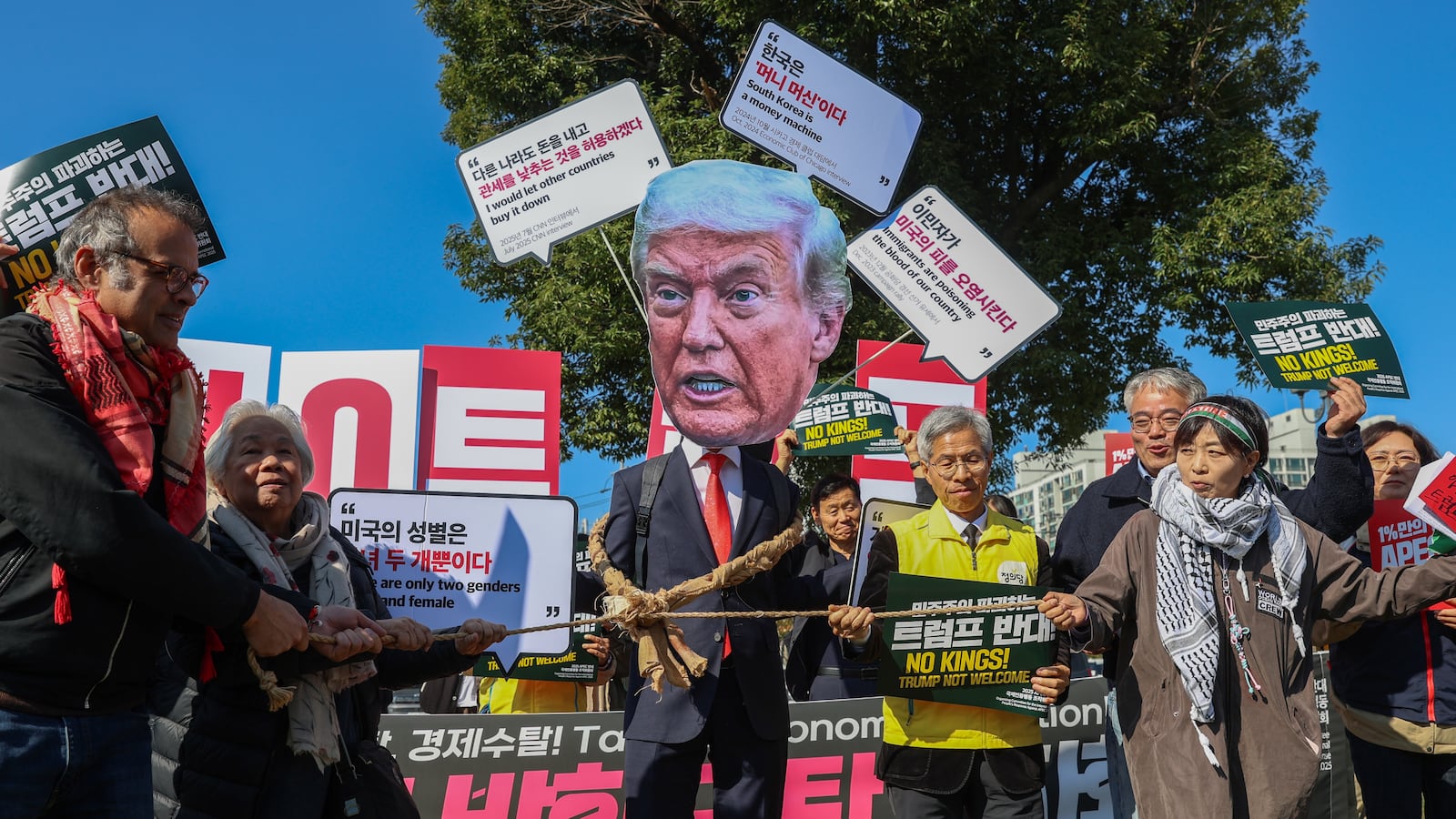 Protesters with placards reading 'No Kings, Trump not welcome' chant slogans during a protest against Unites States President Donald Trump, who is arriving today for the APEC Leaders Week, in Geyongju, South Korea, on October 29, 2025.