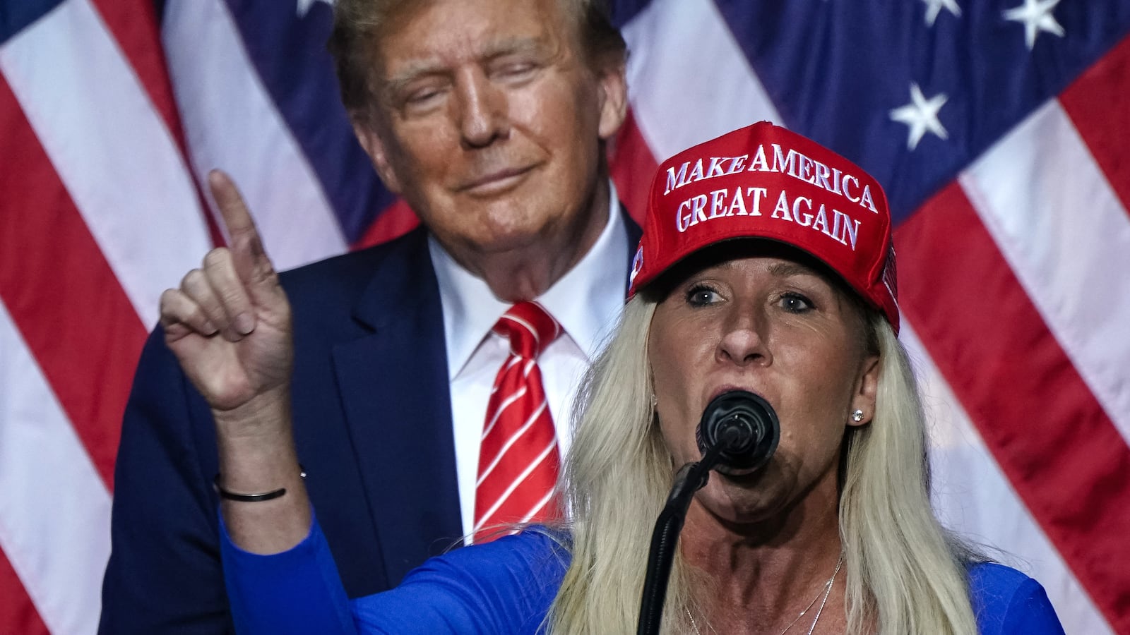 US Representative Marjorie Taylor Greene (R) speaks alongside former US President and 2024 presidential hopeful Donald Trump at a campaign event in Rome, Georgia, on March 9, 2024.