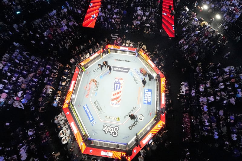 Derrick Lewis is down on the mat as he fights Josh Hokit in their heavyweight bout at UFC Freedom 250 on the South Lawn of the White House, Sunday, June 14, 2026, in Washington.     Alex Brandon/Pool via REUTERS
