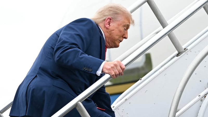 US President Donald Trump trips while boarding Air Force One prior to departure from Morristown Municipal Airport in Morristown, New Jersey, on June 8, 2025, en route to Camp David. (Photo by ANDREW CABALLERO-REYNOLDS / AFP) (Photo by ANDREW CABALLERO-REYNOLDS/AFP via Getty Images)