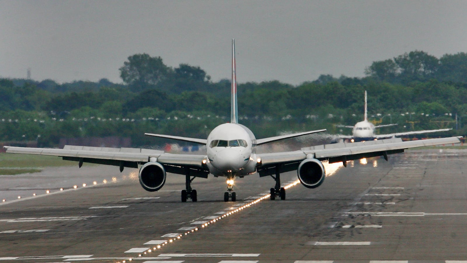 Passenger planes prepare for take off from Gatwick Airport in Sussex.