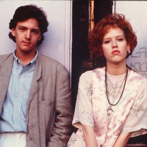 A photo still of Andrew McCarthy, Molly Ringwald, and Jon Cryer