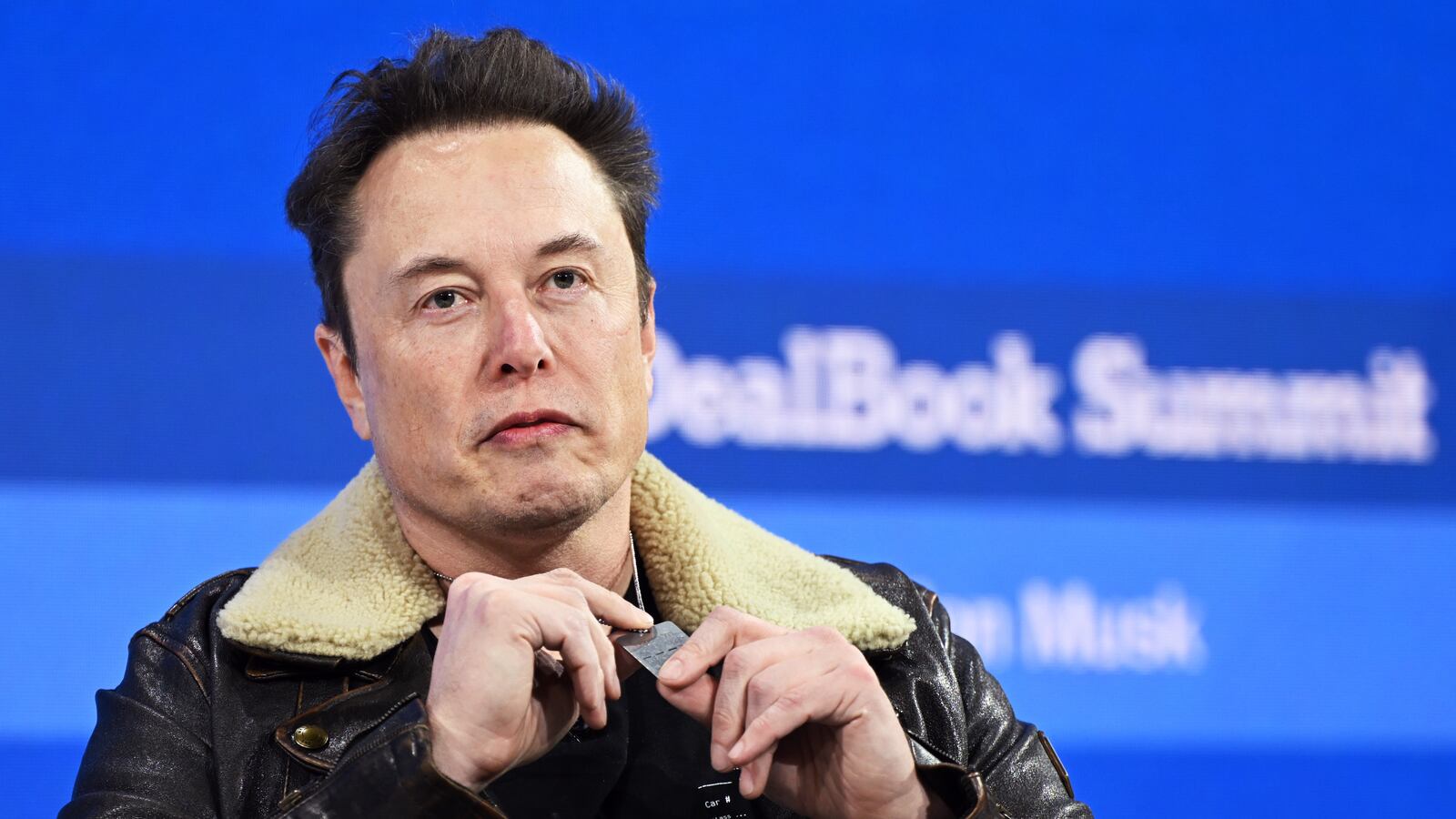 NEW YORK, NEW YORK - NOVEMBER 29: Elon Musk wears a necklace in honor of Israeli hostages onstage during The New York Times Dealbook Summit 2023 at Jazz at Lincoln Center on November 29, 2023 in New York City. (Photo by Slaven Vlasic/Getty Images for The New York Times)