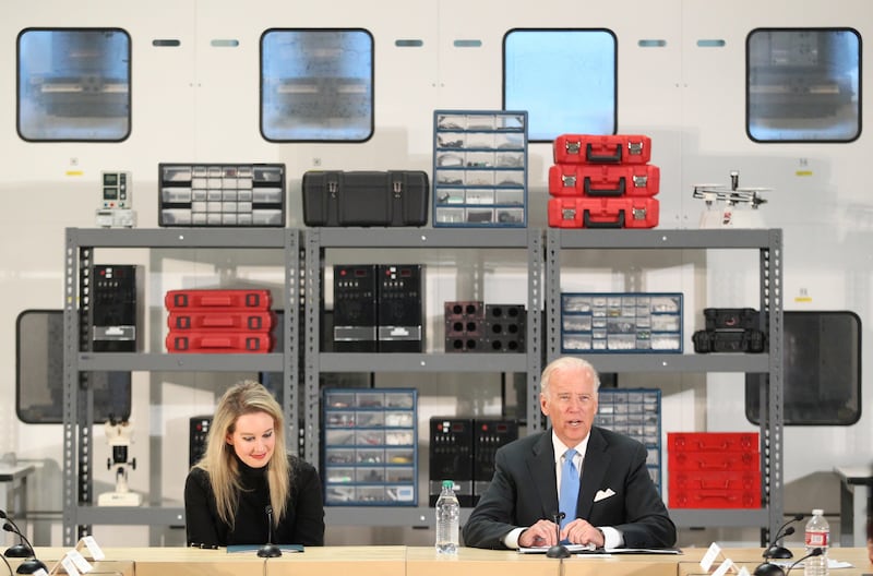 Vice President Joe Biden, right, speaks as Elizabeth Holmes, founder and CEO of Theranos, left, listens during a visit to Theranos manufacturing in Newark, Calif., on Thursday, July 23, 2015.