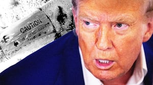 Donald Trump slack jawed in front of a piece of a f-15 jet that was shot down by Iran