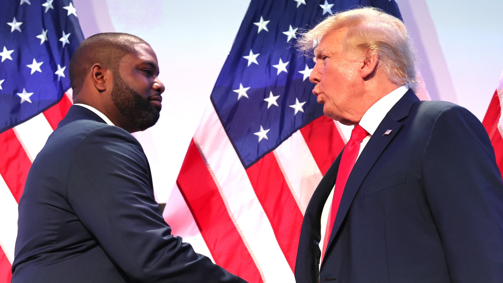 Rep. Byron Donalds (R-FL) shakes hands with former U.S. President Donald Trump