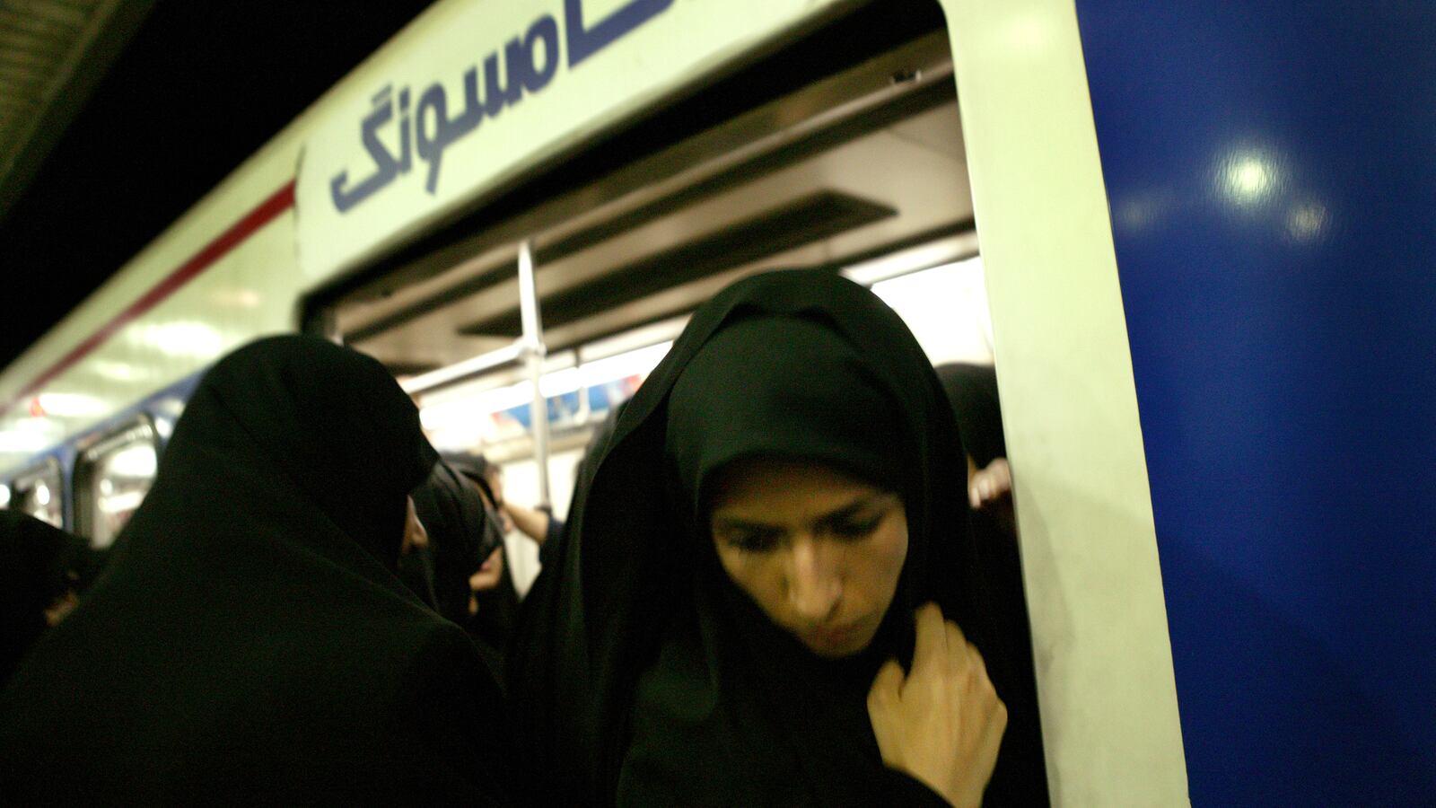Iranian women exit the train in Tehran's Metro