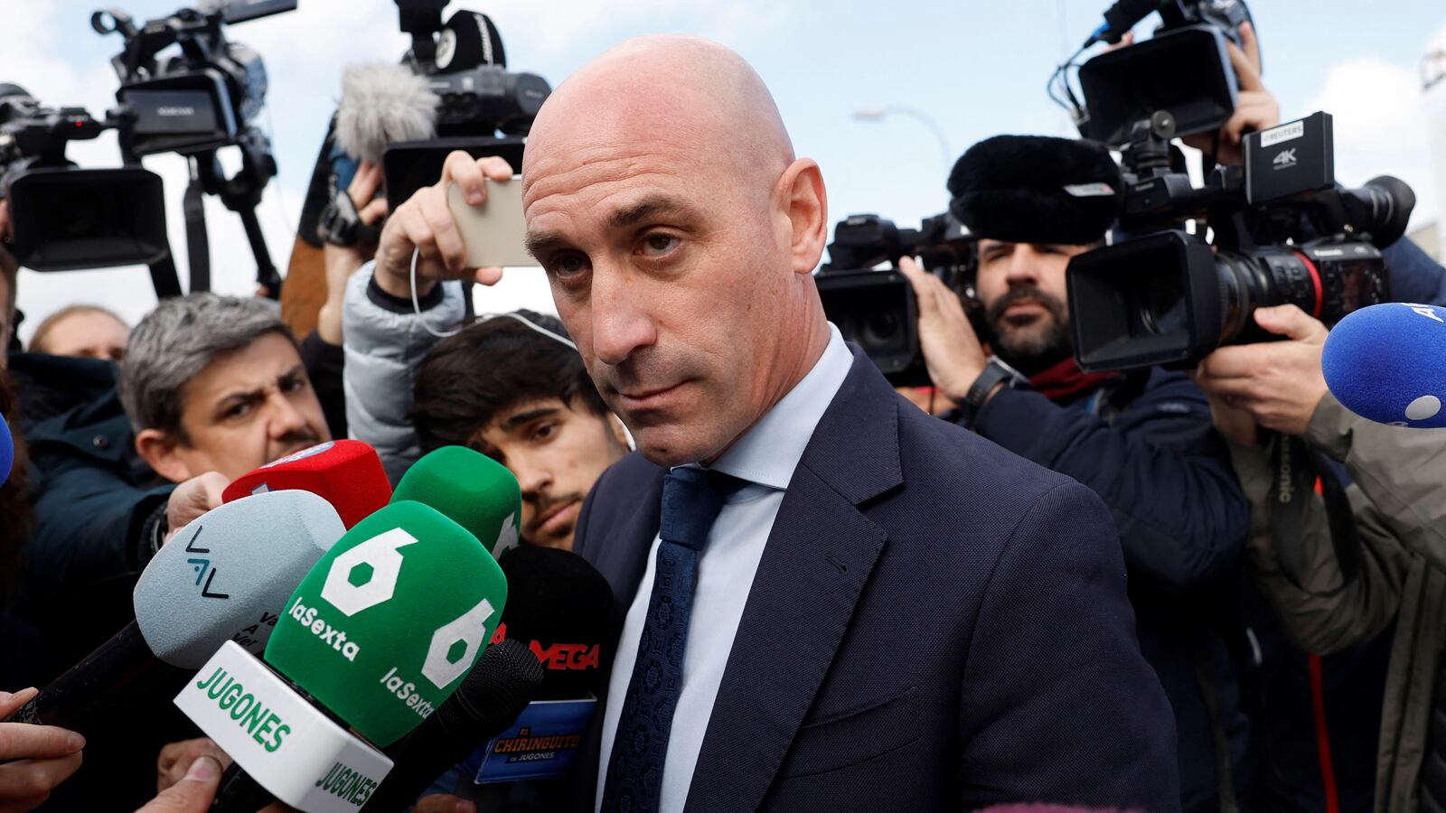 TOPSHOT - Former president of the Spanish football federation Luis Rubiales, accused of sex assault and coercion over forcible kiss, is surrounded by media as he leaves after taking the stand during his trial at the court of San Fernando de Henares, east of Madrid, on February 11, 2025. Spain's former football federation chief has given his version of events in his trial over his forced kiss on player Jenni Hermoso. The 47-year-old provoked worldwide outrage after he cupped Hermoso's head and gave her an unsolicited kiss during the medal ceremony after Spain won the 2023 Women's World Cup in Australia. (Photo by OSCAR DEL POZO / AFP) (Photo by OSCAR DEL POZO/AFP via Getty Images)