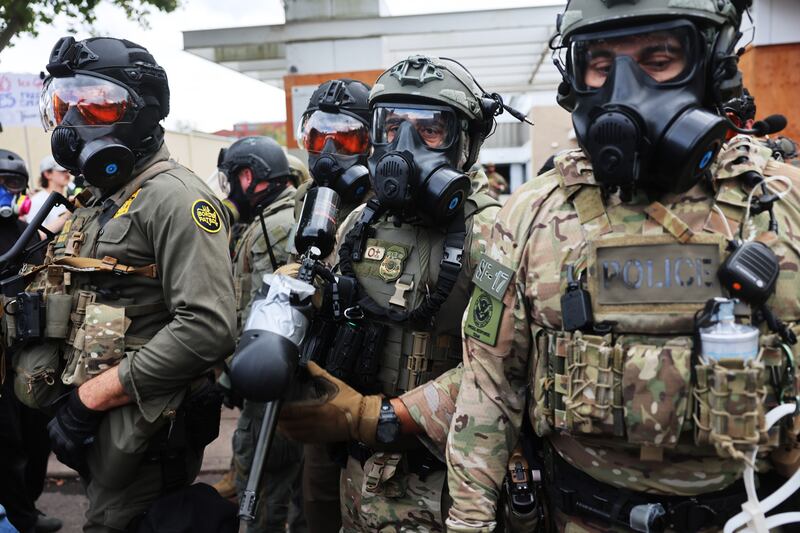 Federal agents, including members of the Department of Homeland Security, the Border Patrol, and police, attempt to keep protesters back outside a downtown U.S. Immigration and Customs Enforcement (ICE) facility on October 04, 2025 in Portland, Oregon.
