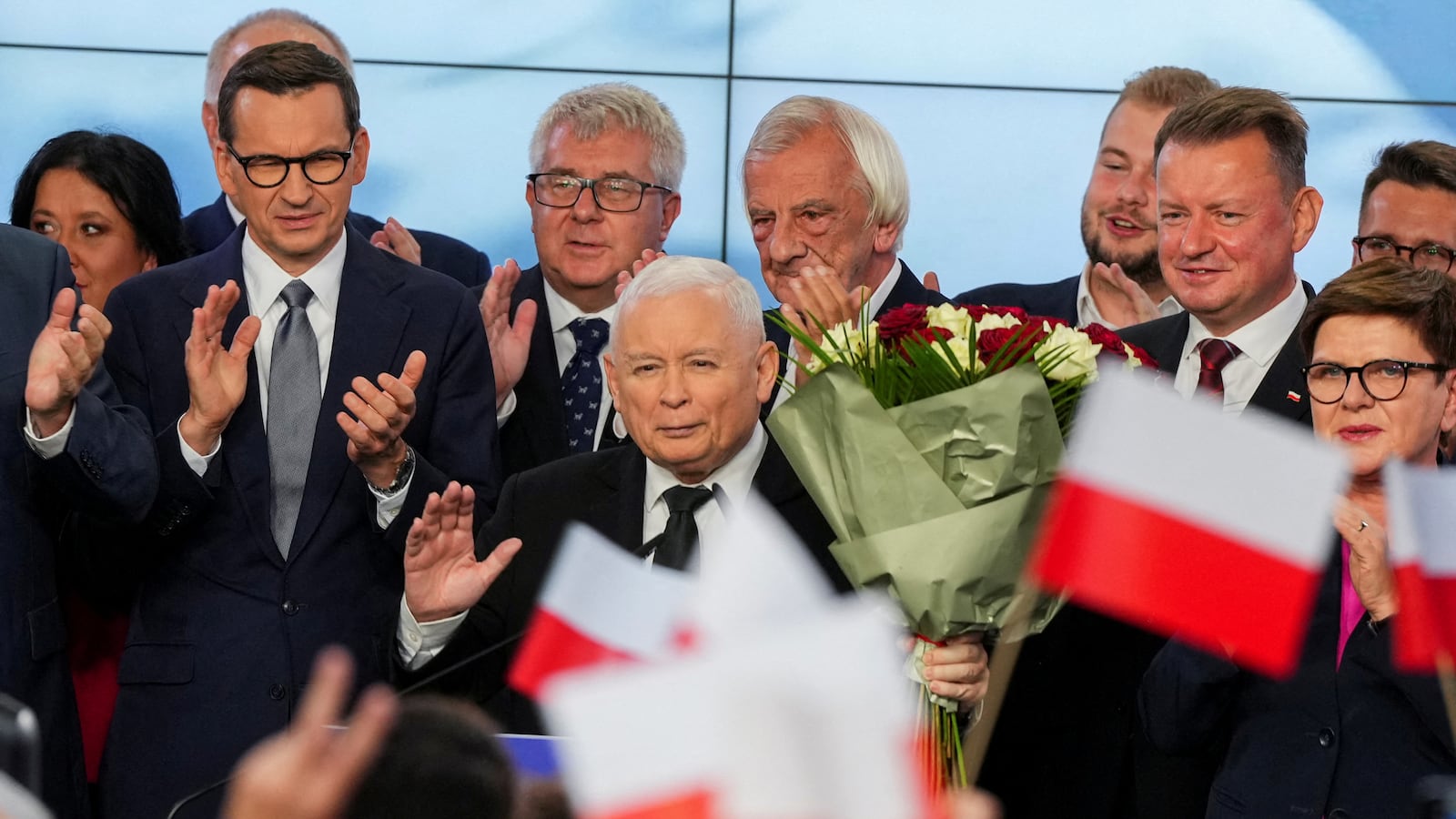 Leader of Poland’s ruling conservative Law and Justice (PiS) party Jaroslaw Kaczynski, holds flowers during a speech after the exit poll results are announced in Warsaw, Poland, Oct. 15, 2023.