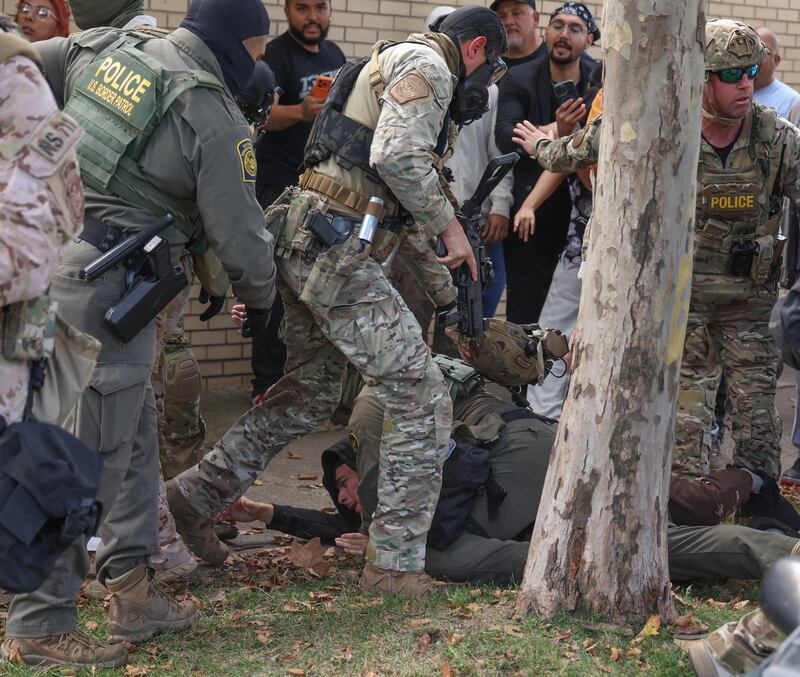 U.S. Border Patrol agents scuffle with community members