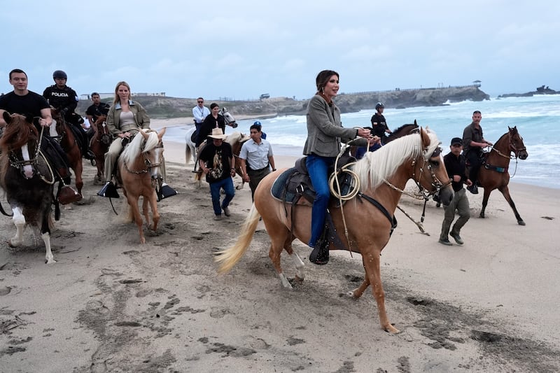 Noem and Ecuador's President Daniel Noboa ride horses.