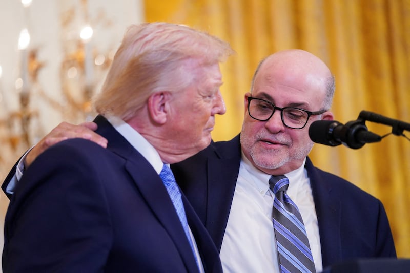 President Donald Trump and Mark Levin on stage at a Hanukkah reception in the East Room of the White House in Washington, D.C., U.S., December 16, 2025.