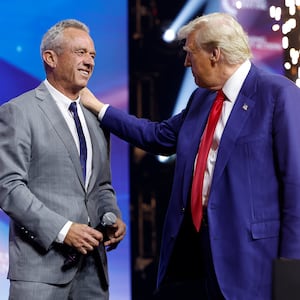 Donald Trump welcomes Robert F. Kennedy Jr. to the stage at a Turning Point Action campaign rally at the Gas South Arena on October 23, 2024 in Duluth, Georgia.