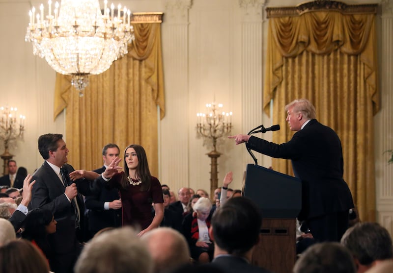 A White House staff member reaches for the microphone held by CNN's Jim Acosta as he questions U.S. President Donald Trump during a news conference following Tuesday's midterm U.S. congressional elections at the White House in Washington, U.S., November 7, 2018.