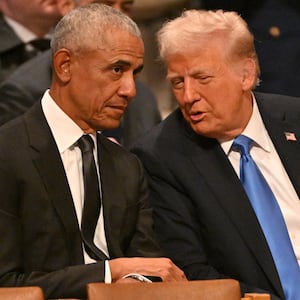 Former US President Barack Obama speaks with President Donald Trump.