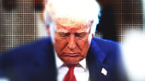 Donald Trump looking down with graph paper in the background