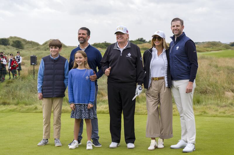 US President Donald Trump, with grandchildren Spencer and Chloe Trump, Donald Trump Junior (left), and Eric and Lara Trump on the first tee during the official opening of the New Course, the second championship course at Trump International Golf Links, on the Menie Estate in Balmedie, Aberdeenshire. The president is opening up a new course dedicated to his Scottish mother, who grew up on the Isle of Lewis, as part of his five-day private trip to the country. Picture date: Tuesday July 29, 2025. (Photo by Jane Barlow/PA Images via Getty Images)