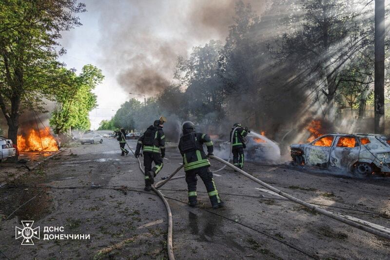 Firefighters work next to burning vehicles at a site of a Russian airstrike, amid Russia's attack on Ukraine, in the frontline city of Kramatorsk in the Donetsk region, Ukraine, May 5, 2026.