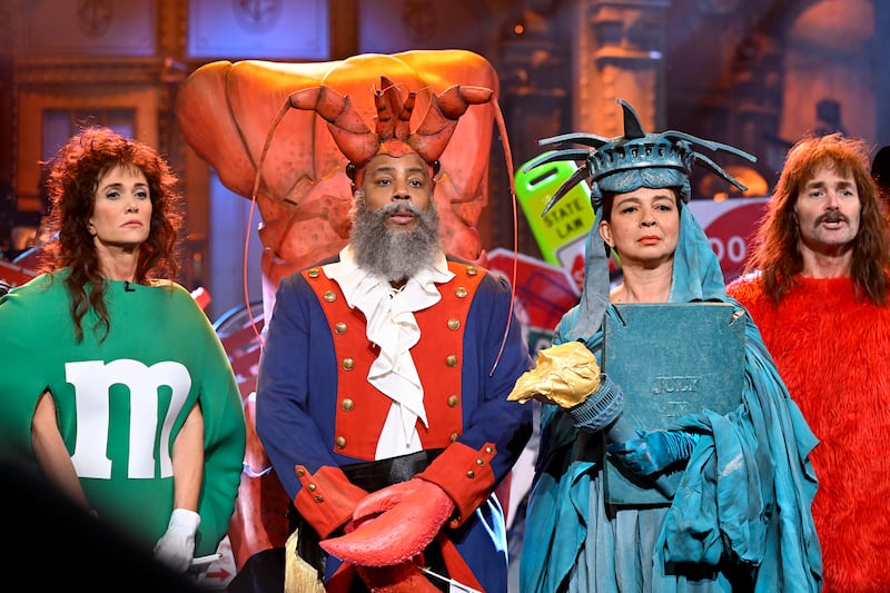 SNL50: THE ANNIVERSARY SPECIAL -- Pictured: (l-r) Kristen Wiig as the Green M&M, Kenan Thompson as the Diner Lobster, Maya Rudolph as the Statue of Liberty, and Will Forte as a Times Square Elmo during the “New York 50th Musical” sketch on February 16, 2025