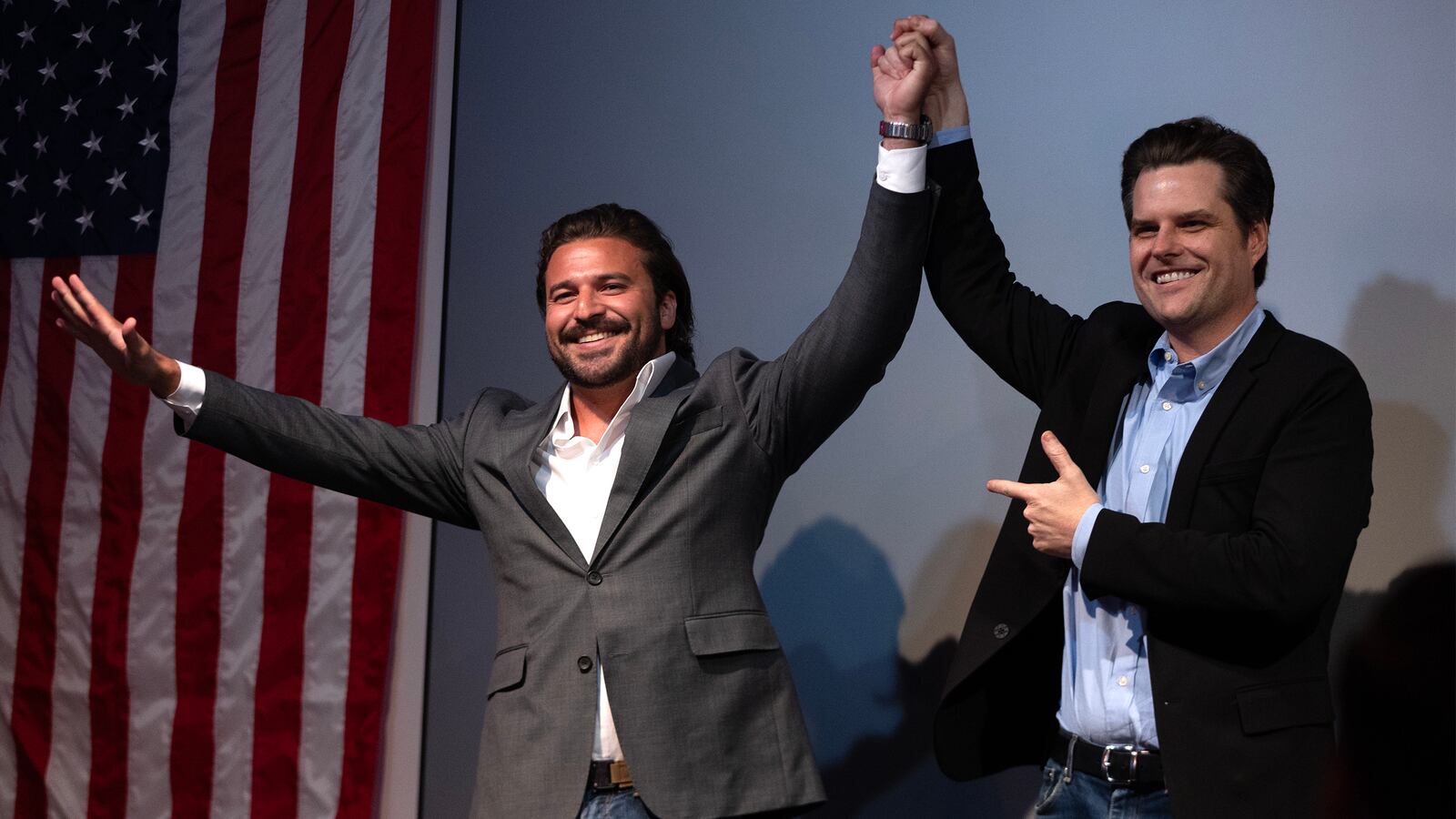 Florida Congressman Matt Gaetz raises Brandon Herrara’s hand after both speak at a rally for Herrara at the Angry Elephant