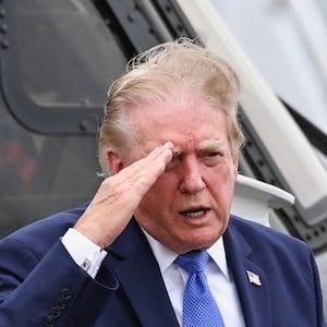 U.S. President Donald Trump salutes after disembarking Marine One at Morristown Municipal Airport in Morristown, New Jersey, U.S., August 2, 2026.