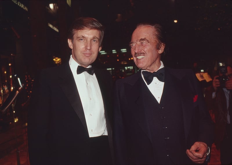 Donald and Fred Trump attend a book release party to celebrate 'Trump: The Art of the Deal' at New York's Trump Tower in 1987. The president's niece says Donald "was never, ever held to account for anything, and he was enabled at every turn."