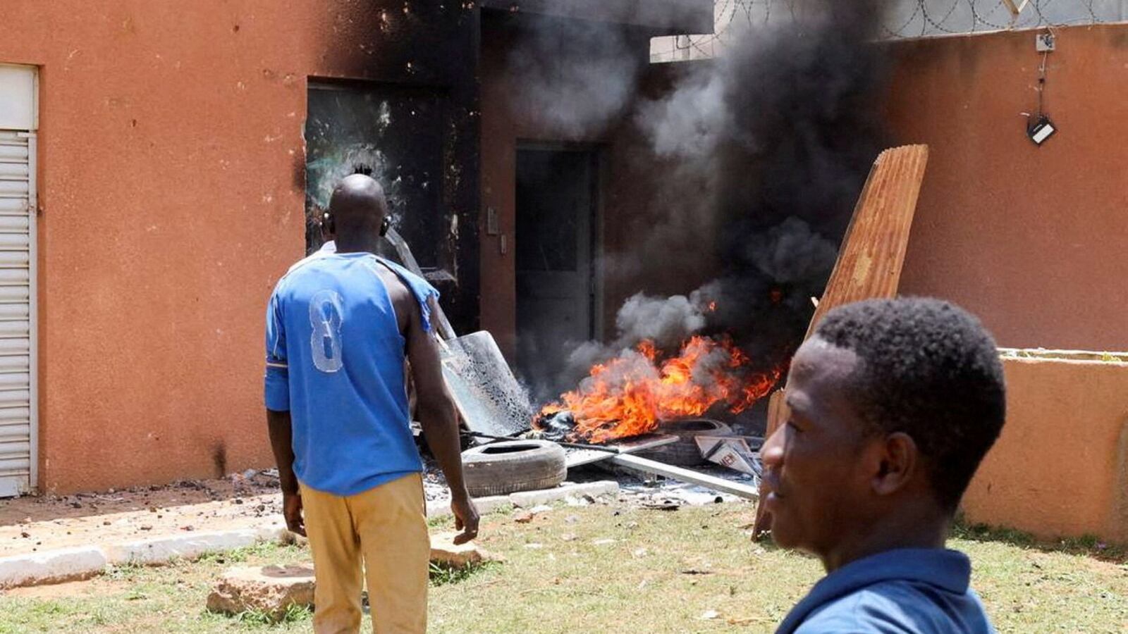 Pro-junta demonstrators gathered outside the French Embassy, try to set it on fire before being dispersed by Nigerien security forces in Niamey, the capital city of Niger, July 30, 2023.
