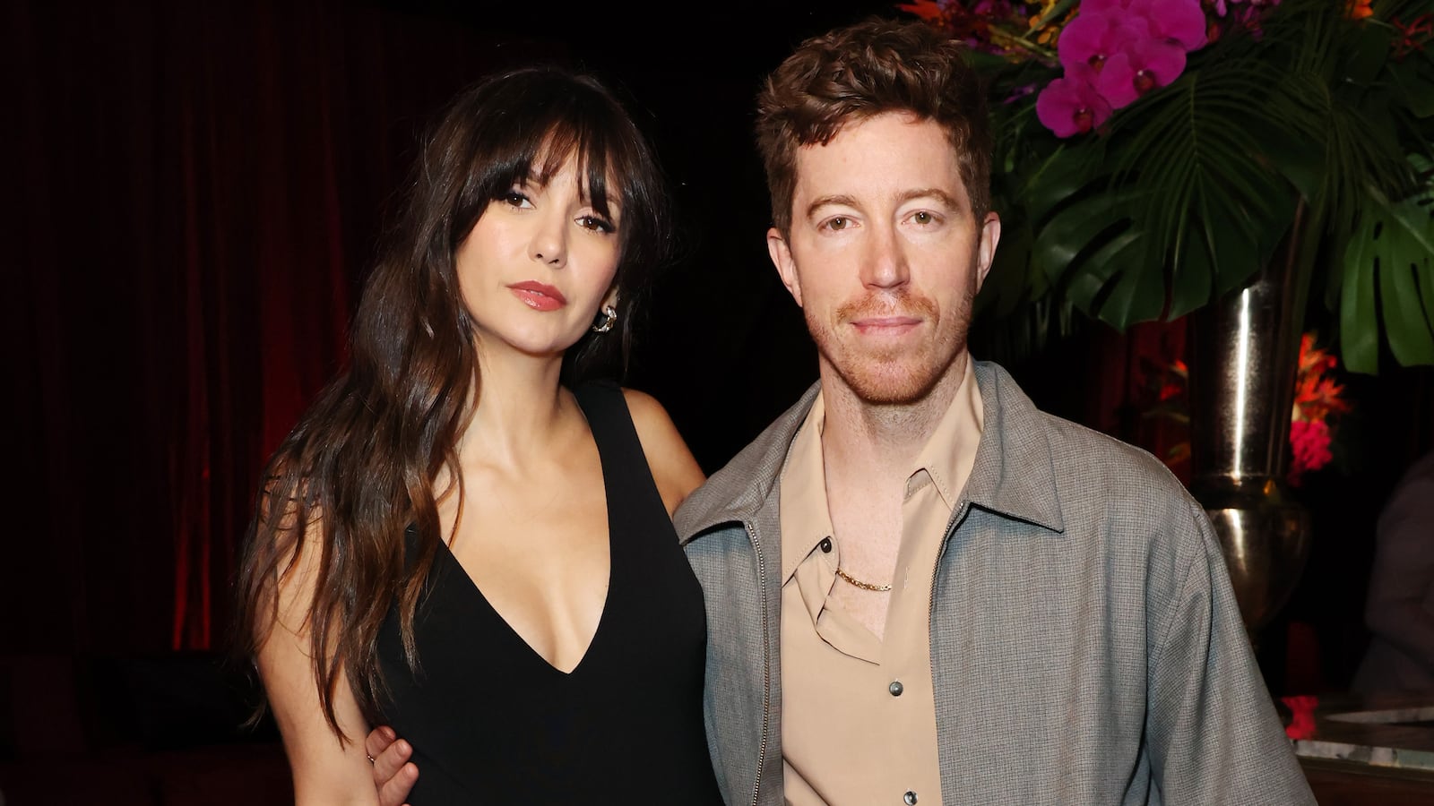 Nina Dobrev and Shaun White on a red carpet.