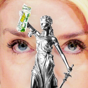 Pam Bondi looking at Lady Justice holding a Subway sandwich