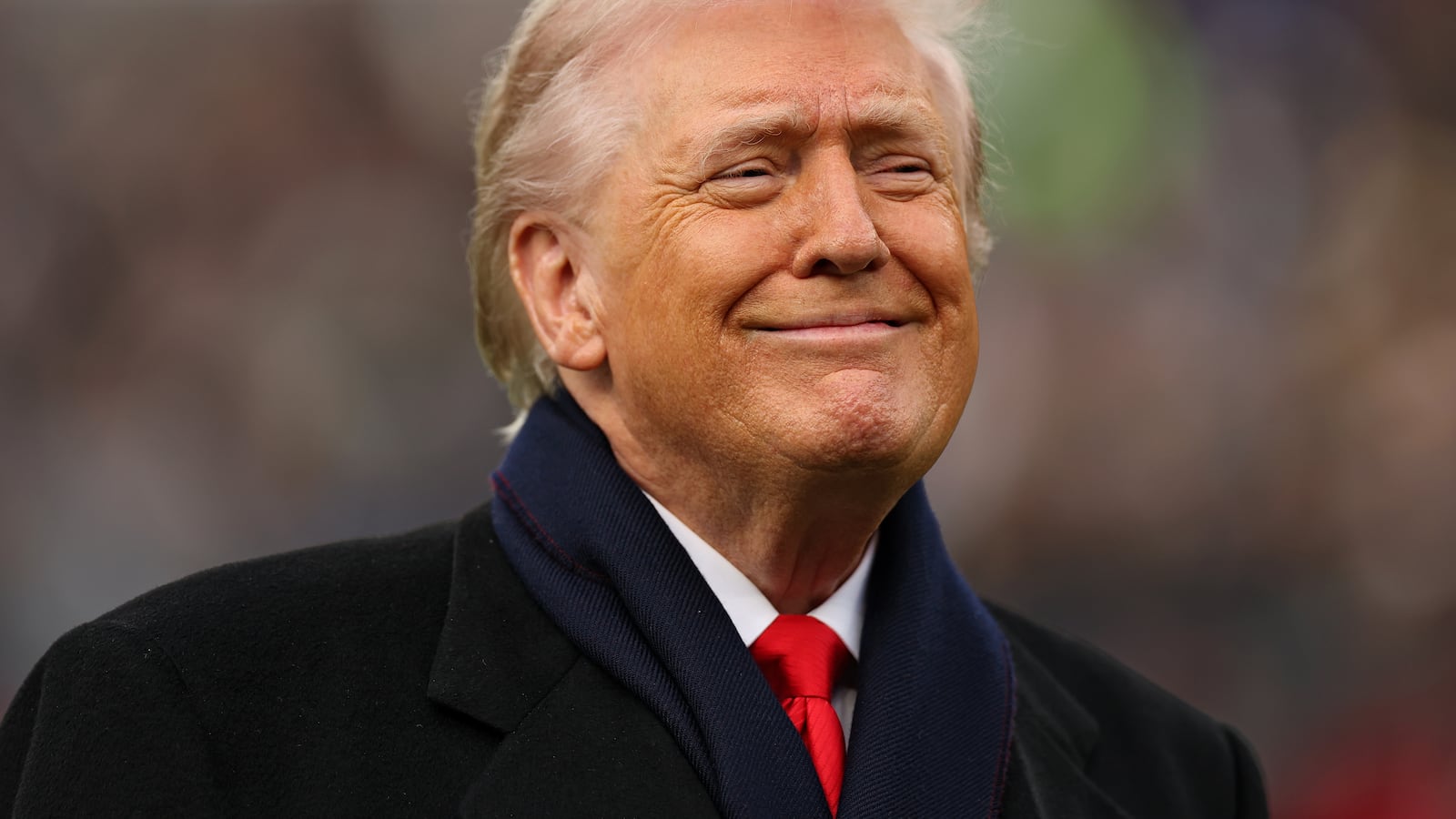 U.S. President Donald Trump smiles from the field before the 126th America's Game between the Army Black Knights and the Navy Midshipmen at M&T Bank Stadium on December 13, 2025 in Baltimore, Maryland. The teams are competing for the Commander-in-Chief's Trophy, with President Trump attending the rivalry for the second consecutive year.