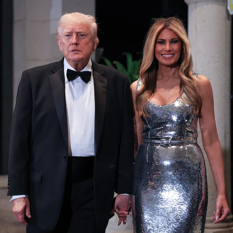 PALM BEACH, FLORIDA - DECEMBER 31: U.S. President Donald Trump and first lady Melania Trump arrive for a New Year’s Eve event at his Mar-a-Lago home on December 31, 2025 in Palm Beach, Florida. The president addressed guests and celebrated the arrival of 2026. (Photo by Joe Raedle/Getty Images)
